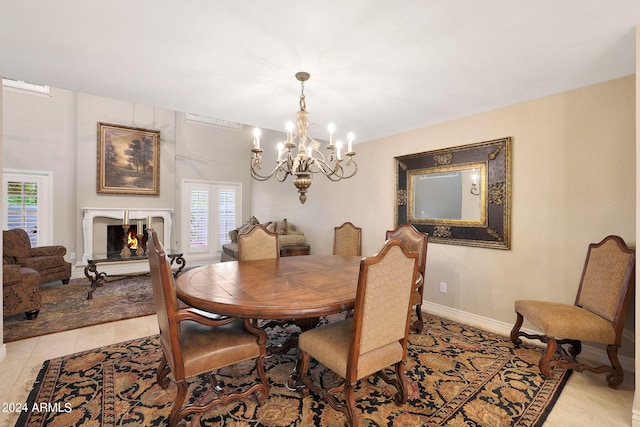 dining space with light tile patterned flooring and a chandelier