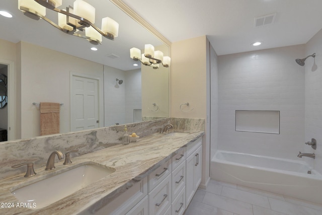 bathroom featuring vanity, tiled shower / bath combo, and tile patterned flooring