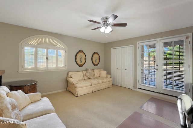 carpeted living room featuring ceiling fan