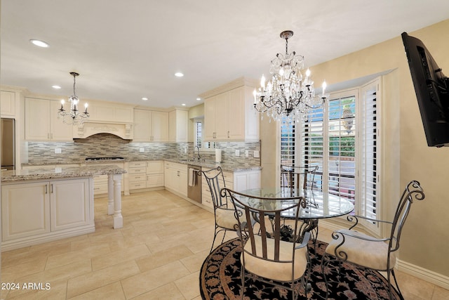 dining area featuring a chandelier and sink