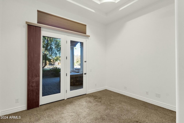 carpeted empty room featuring french doors