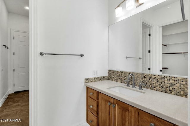 bathroom with vanity and tasteful backsplash