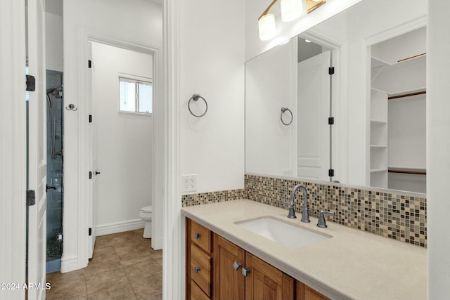 bathroom with tasteful backsplash, vanity, and toilet