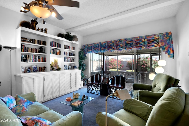 carpeted living room with ceiling fan and a textured ceiling