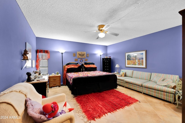 bedroom featuring ceiling fan, a textured ceiling, and light tile patterned floors