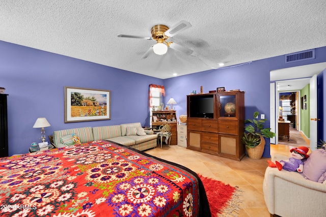 tiled bedroom featuring a textured ceiling and ceiling fan