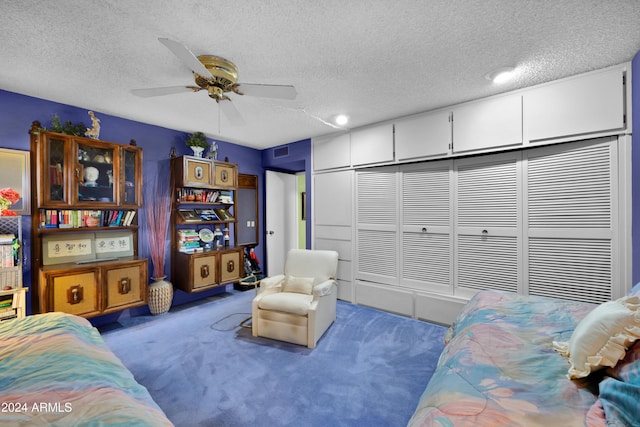 interior space with ceiling fan, carpet flooring, and a textured ceiling