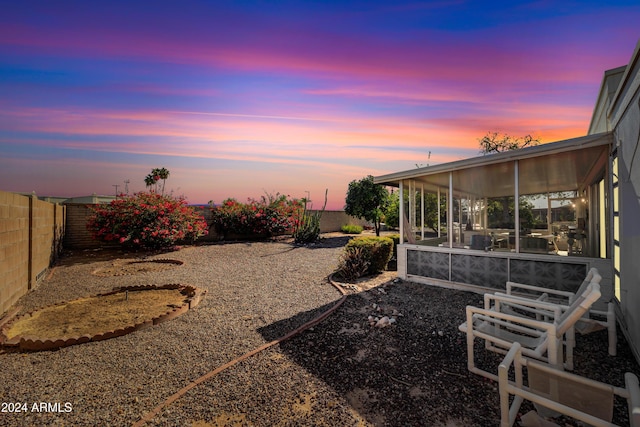 yard at dusk with a sunroom