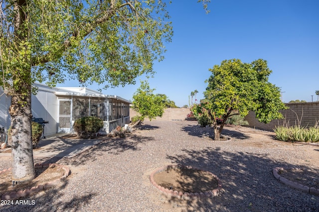 view of yard with a sunroom