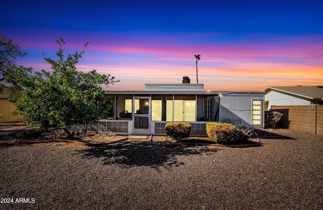 view of front of house featuring a sunroom