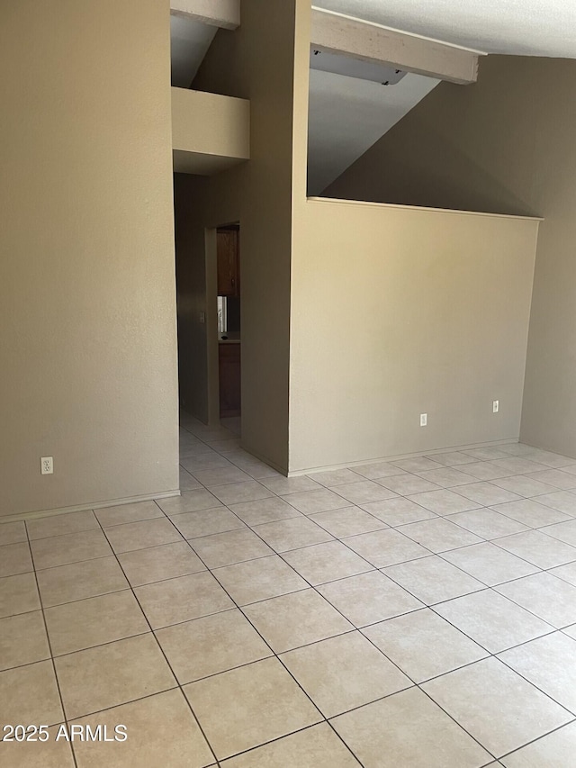 spare room with high vaulted ceiling, beamed ceiling, and light tile patterned floors