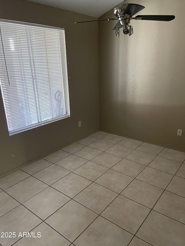 spare room featuring ceiling fan and light tile patterned flooring