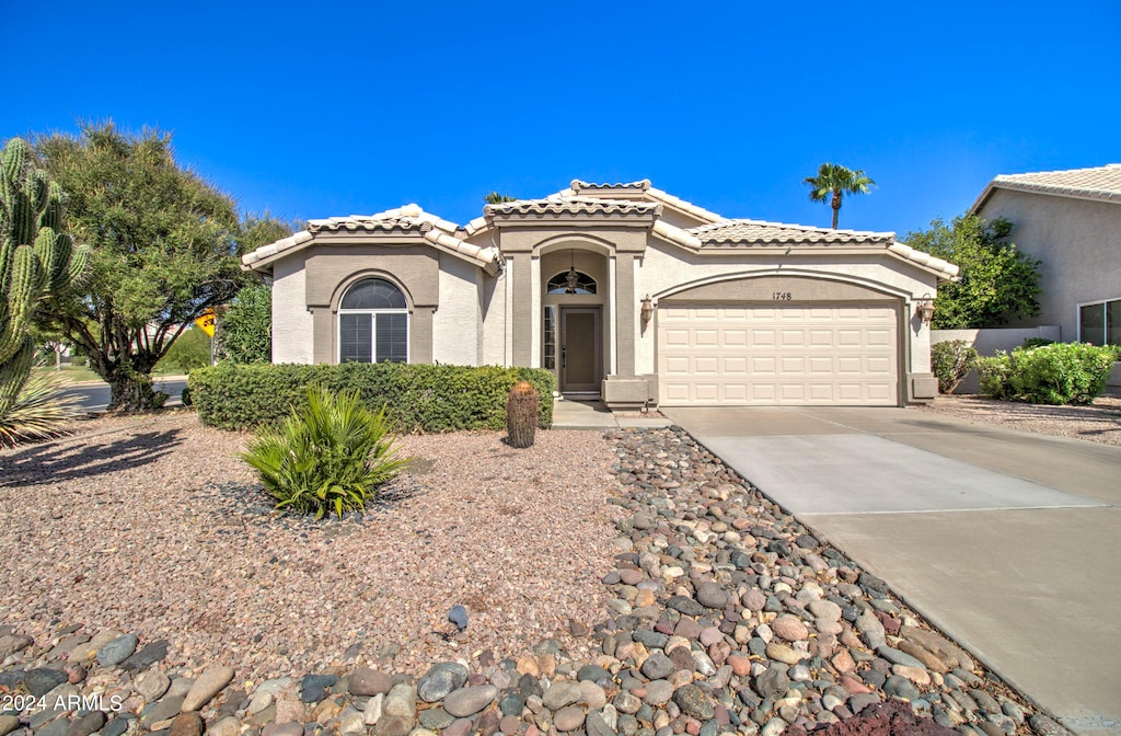 mediterranean / spanish-style home featuring a garage