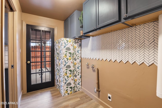 interior space featuring cabinets, light hardwood / wood-style floors, and electric dryer hookup