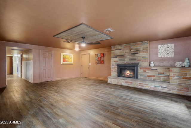 unfurnished living room with ceiling fan, hardwood / wood-style floors, and a fireplace