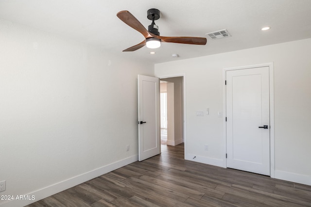 kitchen featuring a center island, stainless steel refrigerator with ice dispenser, a kitchen breakfast bar, white cabinets, and wall chimney range hood