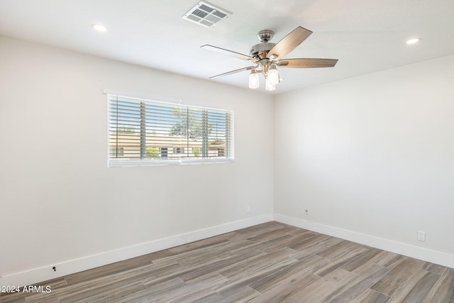 unfurnished bedroom featuring a walk in closet, ceiling fan, dark hardwood / wood-style flooring, and a closet