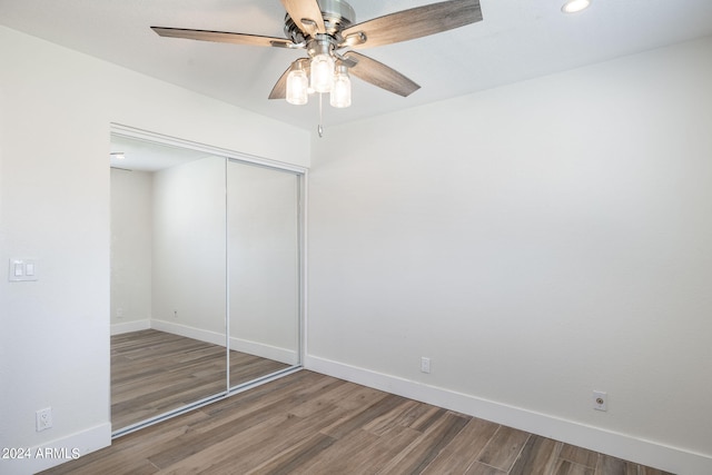 unfurnished bedroom with ceiling fan, a closet, light hardwood / wood-style flooring, and ensuite bath