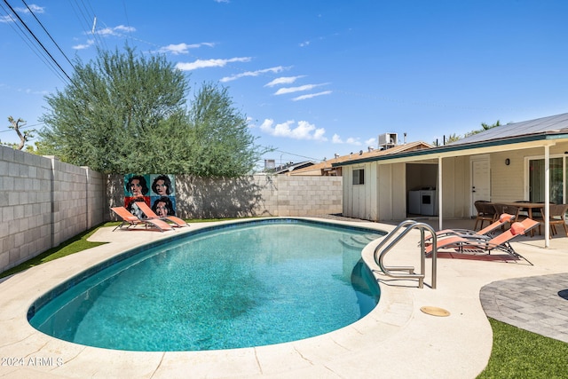 view of patio / terrace with a fenced in pool