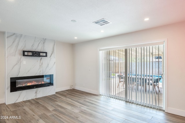 kitchen with wall chimney exhaust hood, a center island, white cabinetry, and appliances with stainless steel finishes