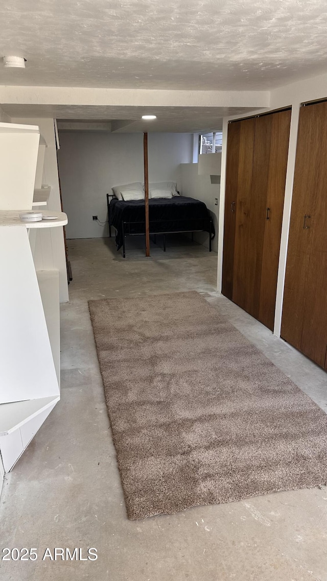 unfurnished bedroom featuring multiple closets and a textured ceiling