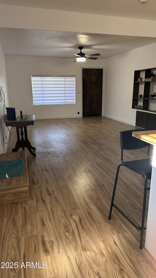 living room featuring hardwood / wood-style floors and ceiling fan