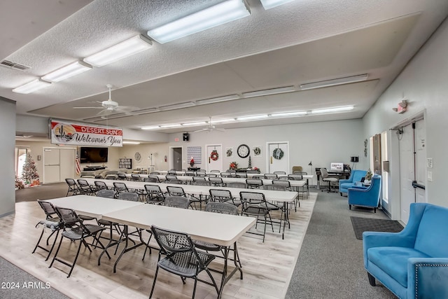 dining area with wood-type flooring and ceiling fan