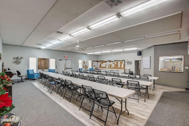 dining area with light wood-type flooring and ceiling fan