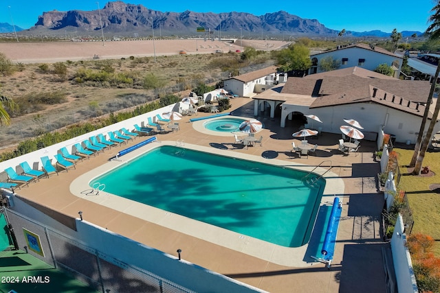 view of pool featuring a mountain view and a patio