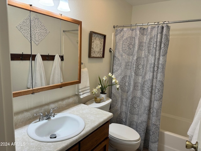 full bathroom featuring shower / tub combo, vanity, and toilet