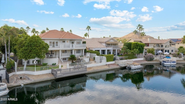 exterior space with a balcony, a water view, and a patio