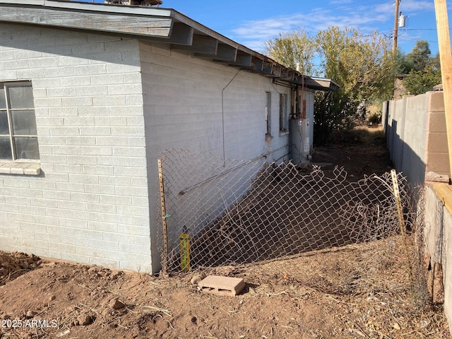 view of side of home with gas water heater