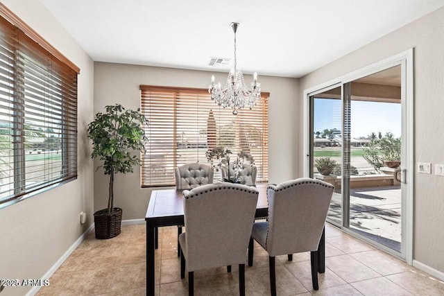 dining area featuring light tile patterned flooring and a chandelier