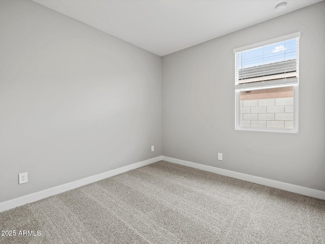 empty room with carpet flooring and baseboards