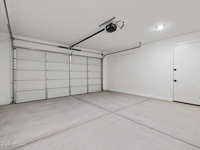 garage with baseboards and a garage door opener