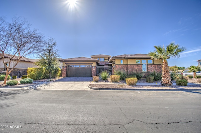 view of front of house featuring an attached garage, concrete driveway, and stucco siding