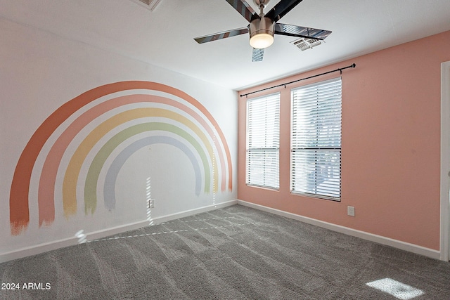 carpeted spare room featuring ceiling fan