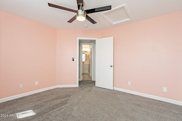 spare room with ceiling fan and carpet