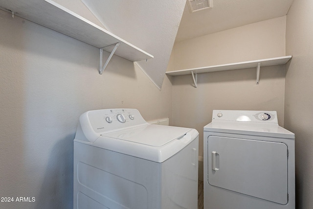 clothes washing area with washer and dryer