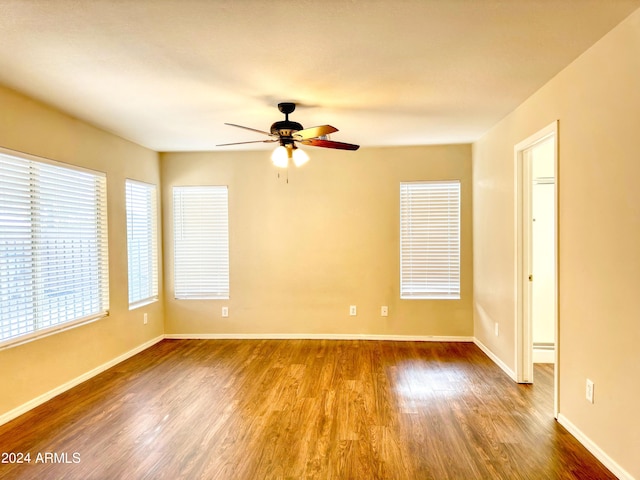 empty room featuring ceiling fan and hardwood / wood-style flooring