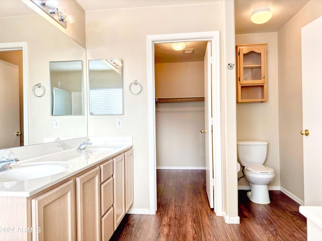 bathroom featuring vanity, hardwood / wood-style floors, and toilet