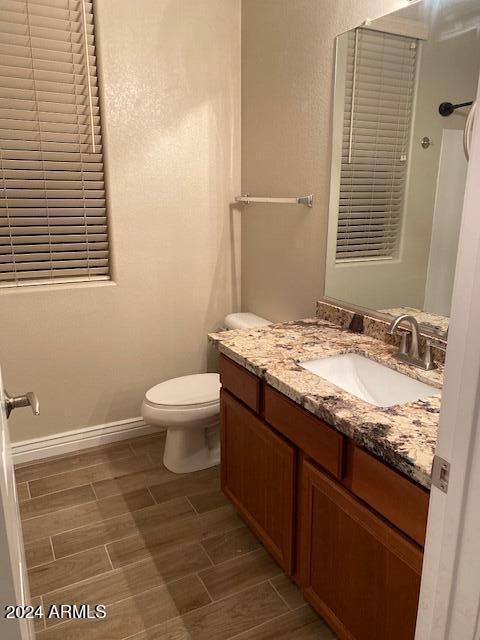 bathroom with vanity, toilet, and walk in shower