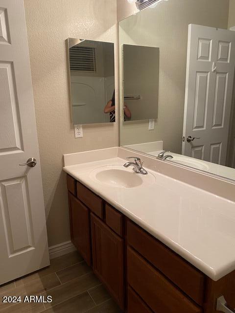 bathroom featuring vanity and wood-type flooring