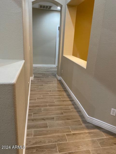 hallway with wood-type flooring