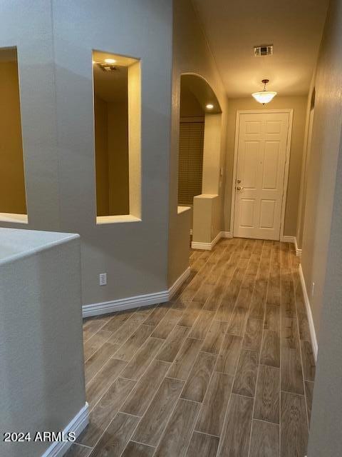 hallway with wood-type flooring