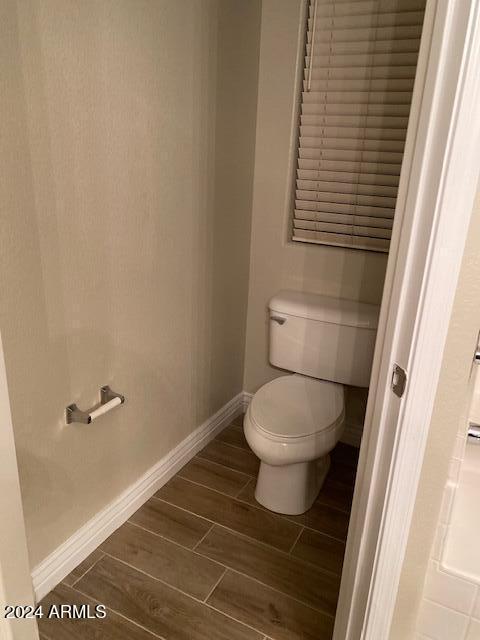 bathroom featuring hardwood / wood-style floors and toilet