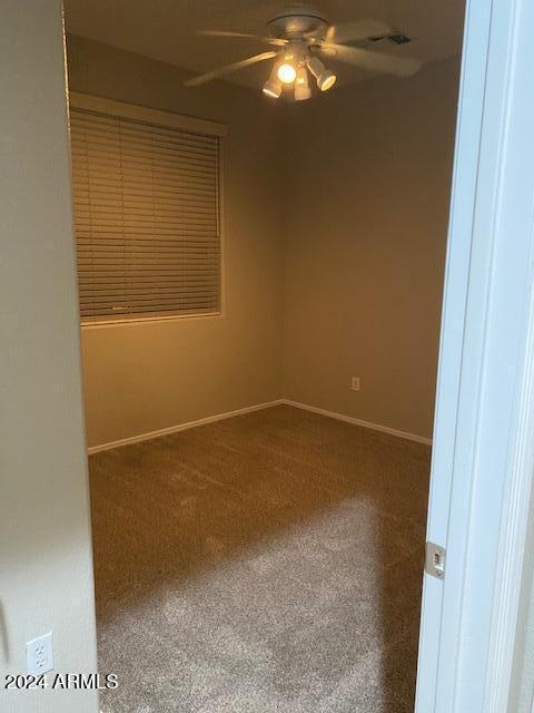 carpeted empty room with ceiling fan