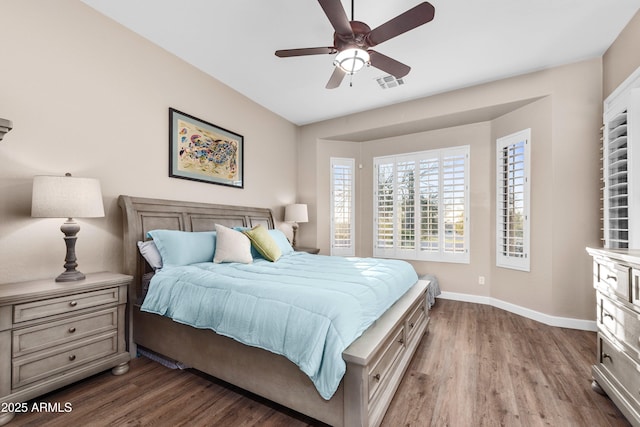 bedroom with ceiling fan and dark hardwood / wood-style flooring