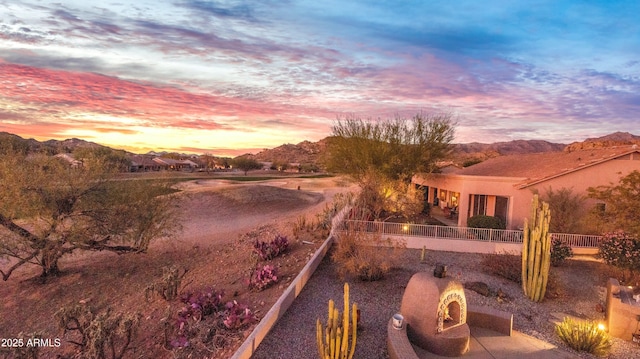 yard at dusk with a mountain view and a patio