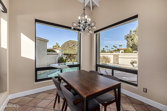 dining area with tile patterned flooring and a notable chandelier